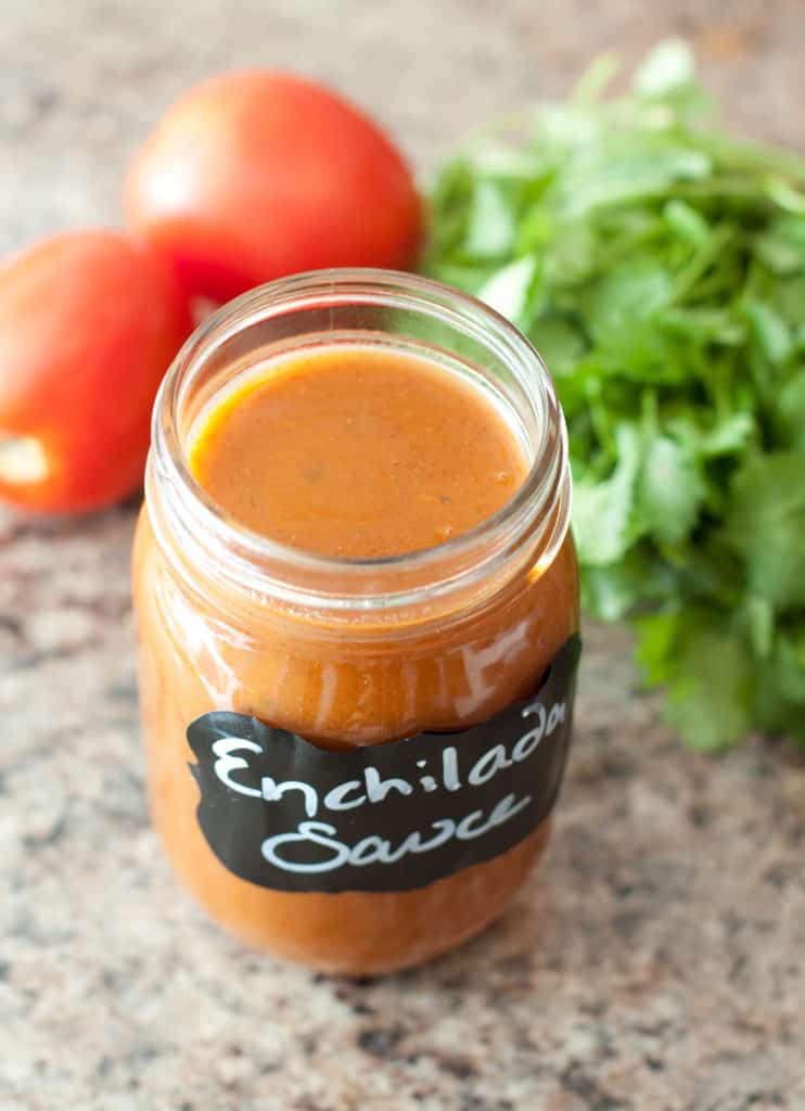 an open jar of enchilada sauce in a mason jar
