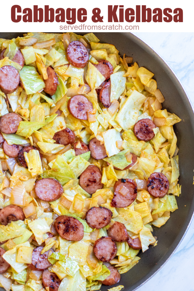 overhead of large pan with cooked kielbasa and cabbage and Pinterest pin text.