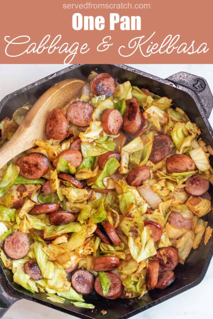 overhead of large pan with cooked kielbasa and cabbage with Pinterest pin text.