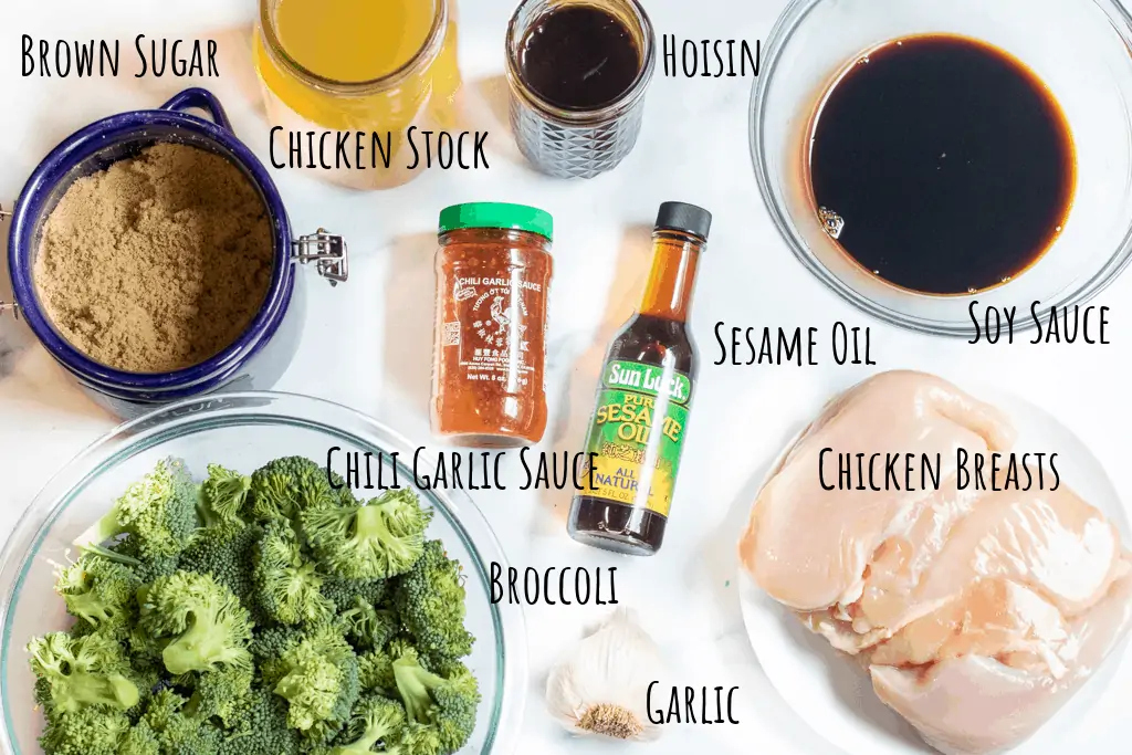 brown sugar, broccoli florets, stock, soy, hoisin, chicken breasts, garlic, sesame oil, and chili garlic sauce on a counter.