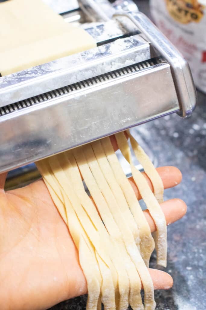 pasta being cut in a pasta roller 