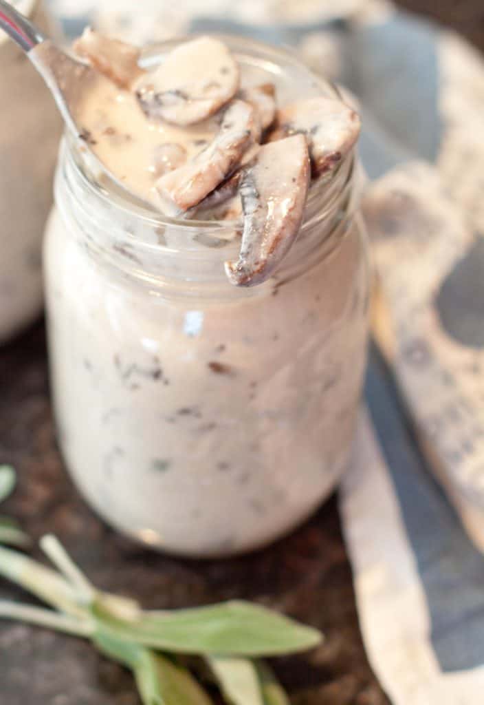 a jar of cream of mushroom soup with a spoon