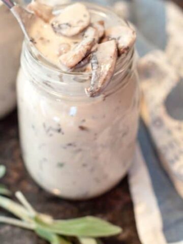 a jar of cream of mushroom soup with a spoon