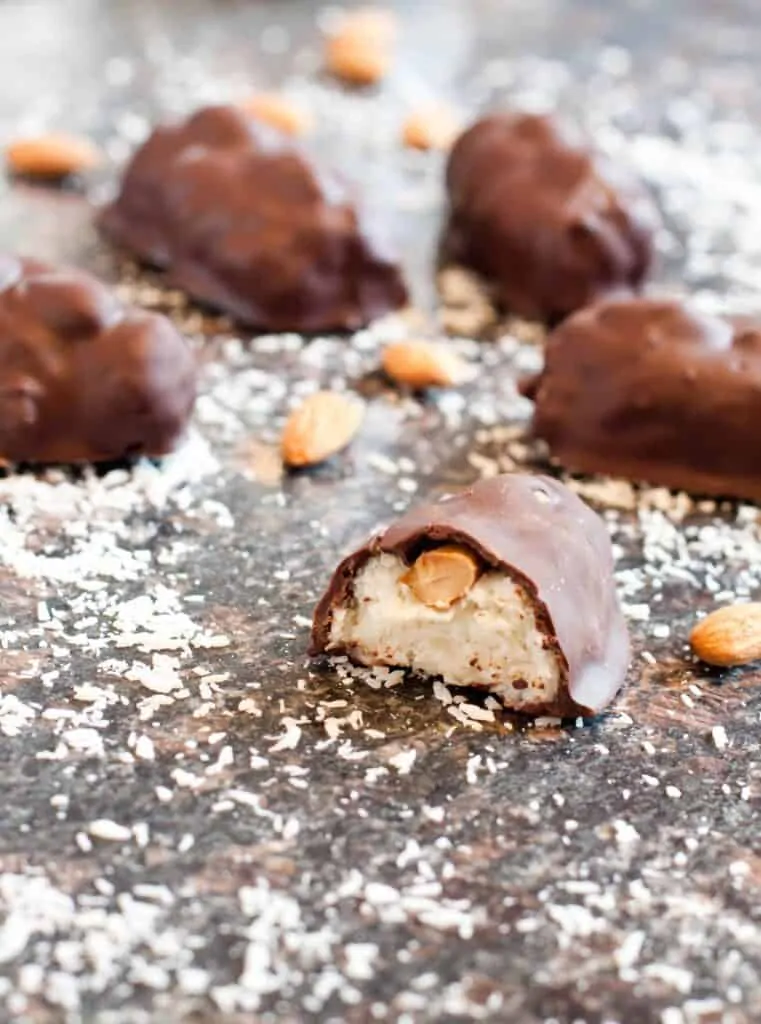 mini almond joy in half on coconut coated counter 