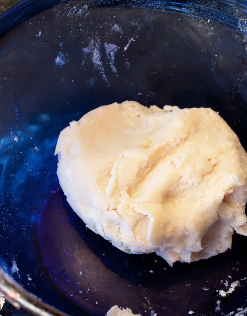 a smooth dough in a blue bowl.