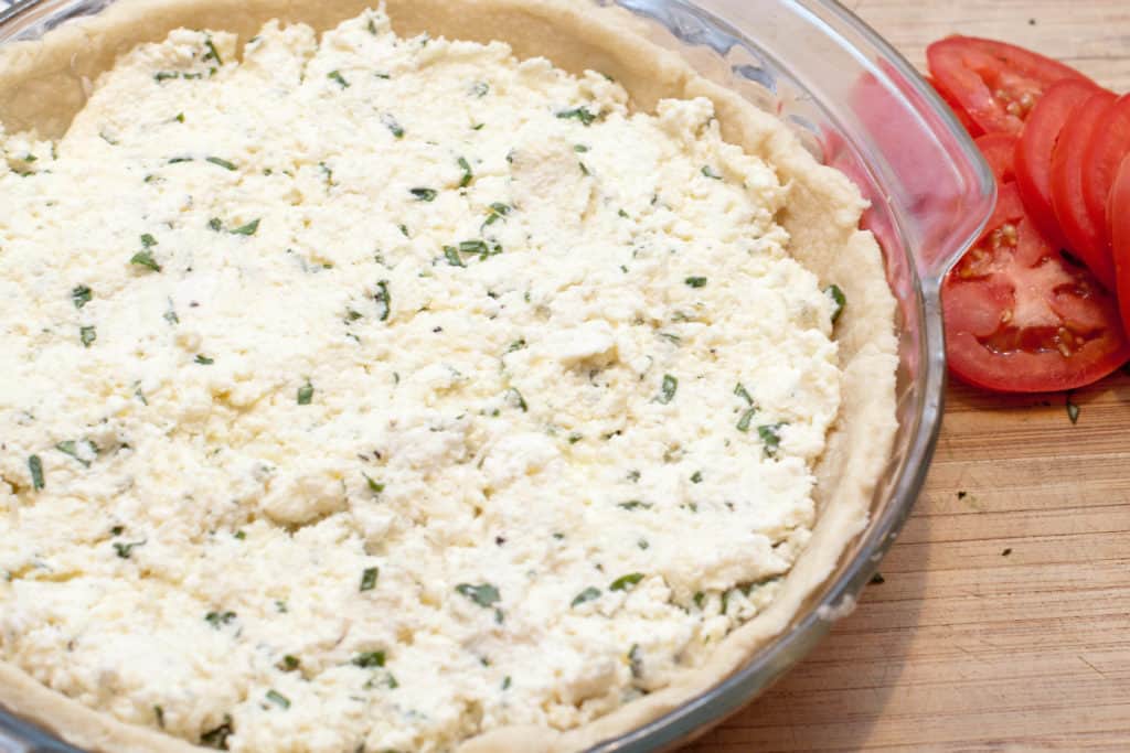 a pie dish filled with basil ricotta mixture.