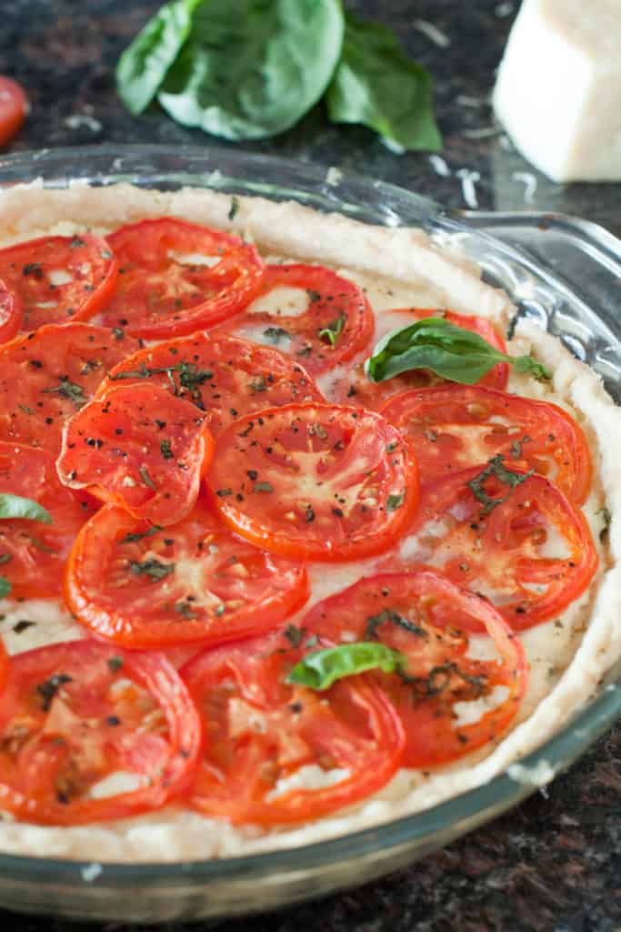 a baked tomato pie with fresh basil.