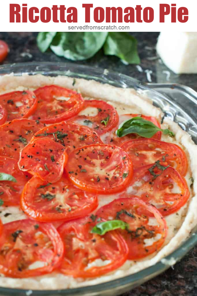 a baked pie of tomatoes and ricotta topped with basil and Pinterest pin text.