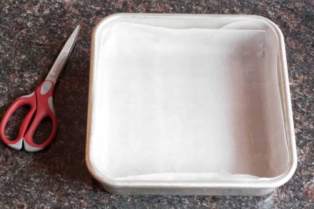 a cleanly cut parchment paper lined square baking dish.