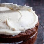 a cake being frosted with a knife.