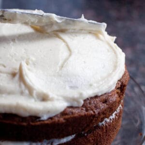 a cake being frosted with a knife.