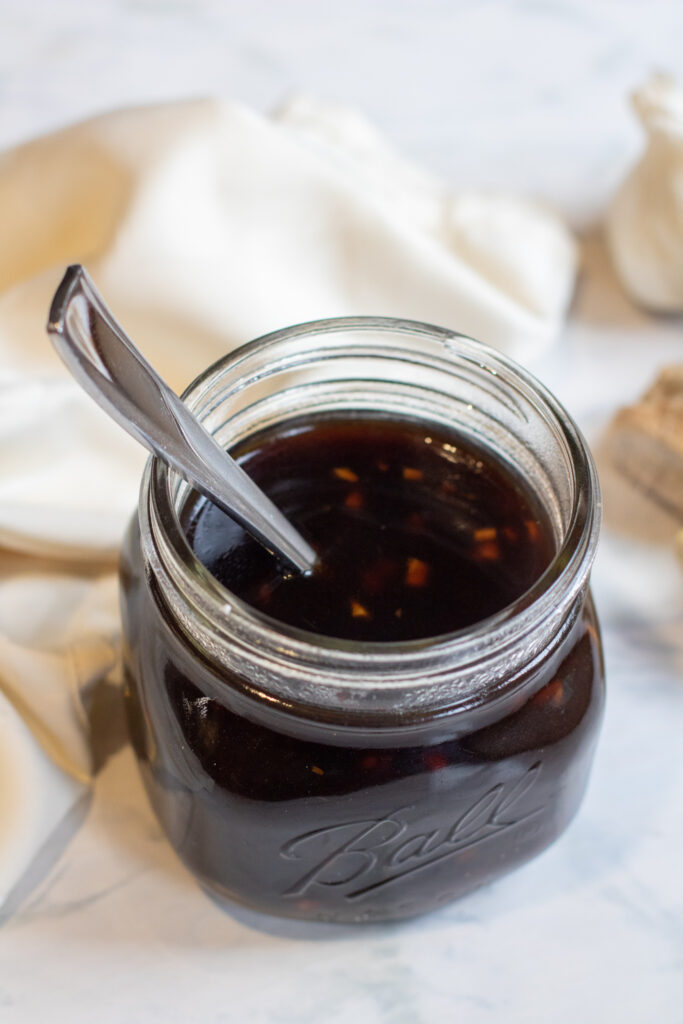 a jar of teriyaki sauce with a spoon