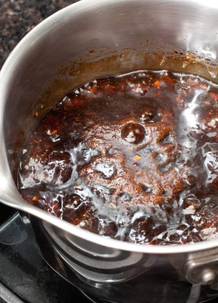 a pot with brown boiling sauce