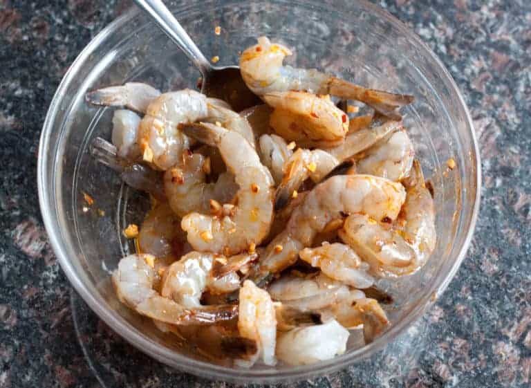 a bowl of marinating shrimp.