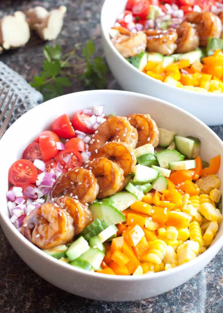 bowl with shrimp and colorful chopped vegetables.