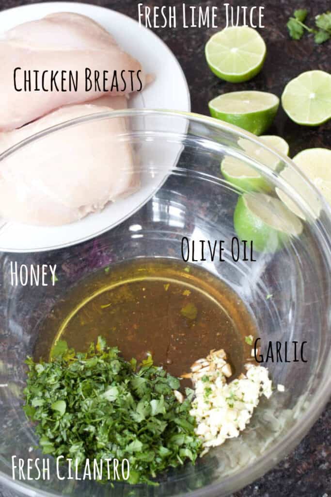 raw chicken, fresh cut limes, and a bowl of honey, olive oil, cilantro, and minced garlic