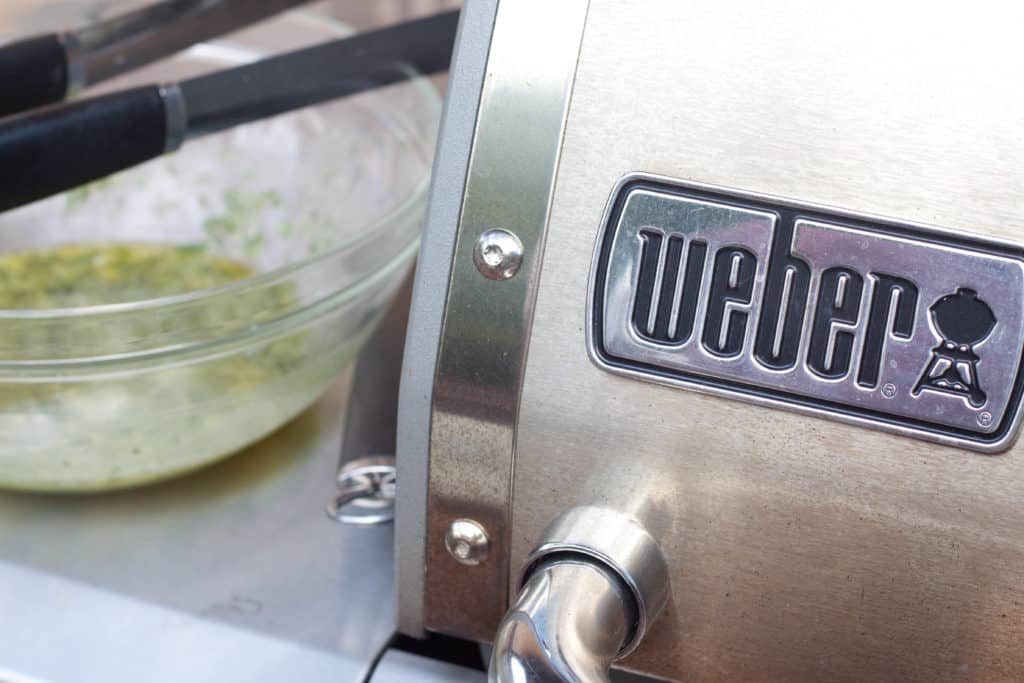 a bowl of marinade and a close up of a weber grill