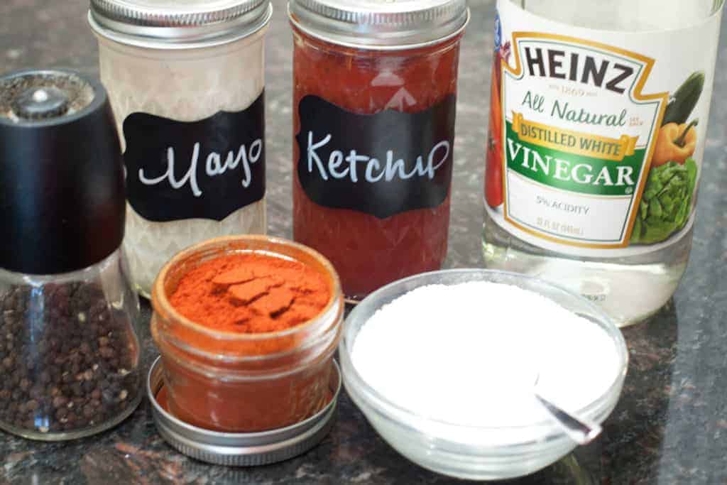 mayo and ketchup jars with white vinegar and spices.