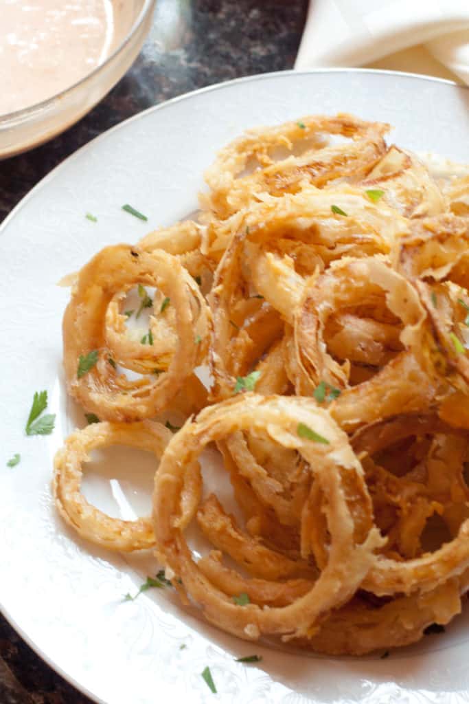 a plate of crispy onion rings. 