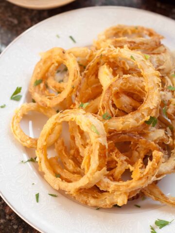 cooked crispy onion rings from scratch on a plate