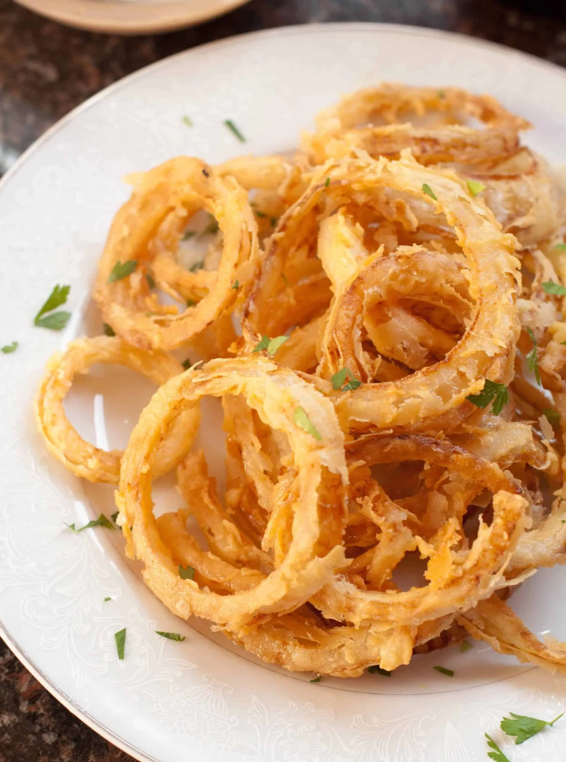 cooked crispy onion rings from scratch on a plate