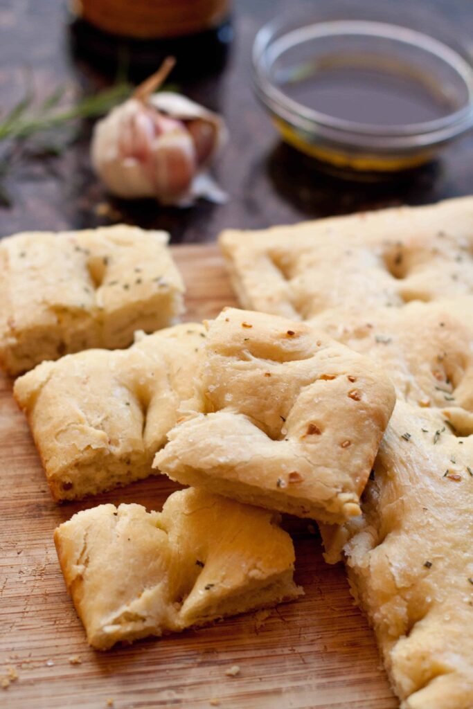 Make your own soft, salty Easy Garlic Rosemary Focaccia bread at home with just a couple of ingredients and minimal work!