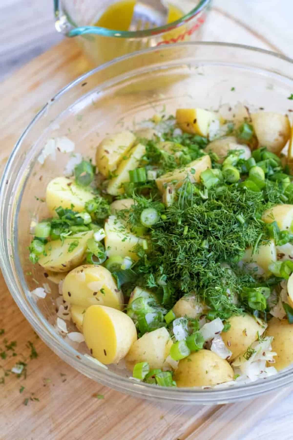 a bowl of potatoes topped with fresh dill.