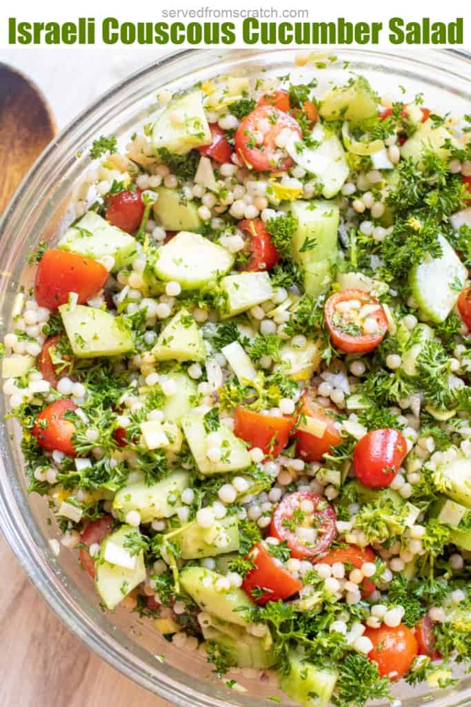 a bowl of couscous with tomatoes and cucumbers and parsley and Pinterest pin text.