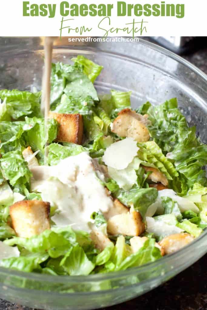 a large bowl of Caesar salad with dressing being poured in.