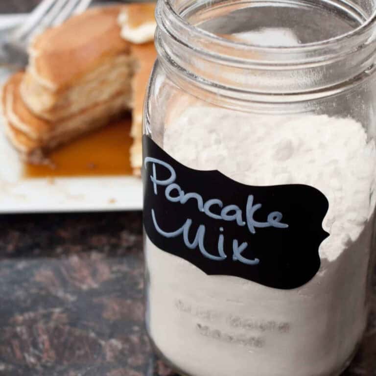 a jar of labeled pancake mix in front of some pancakes.