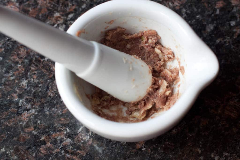 a mortar and pestle with a paste in it.