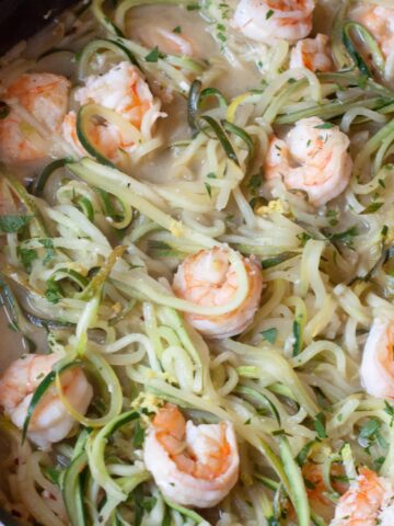 a pan of zucchini noodles and shrimp.