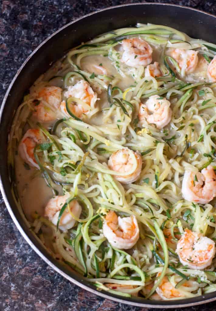 a pan of zucchini noodles and shrimp.