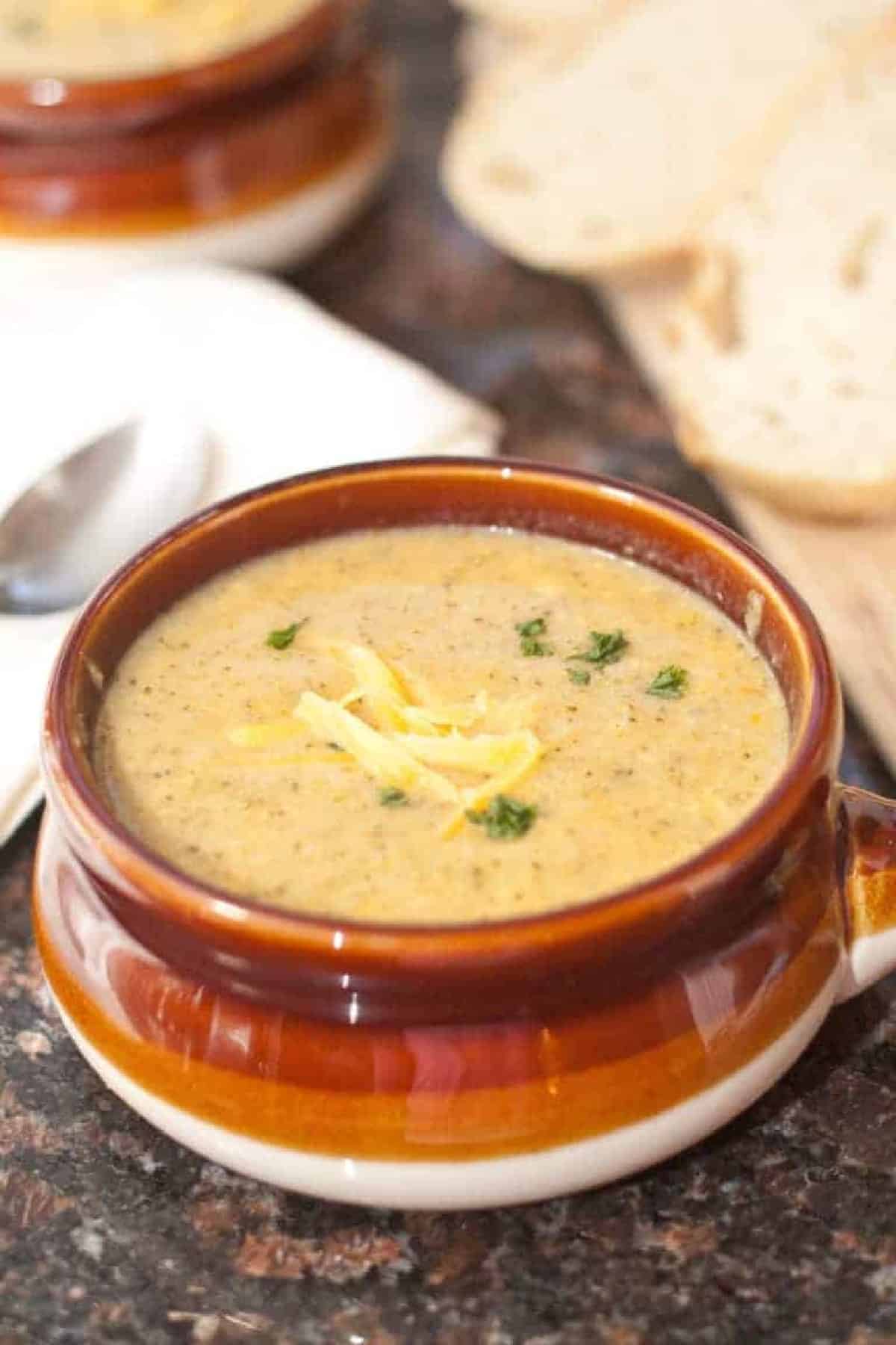 a soup bowl of creamy broccoli cheddar soup.