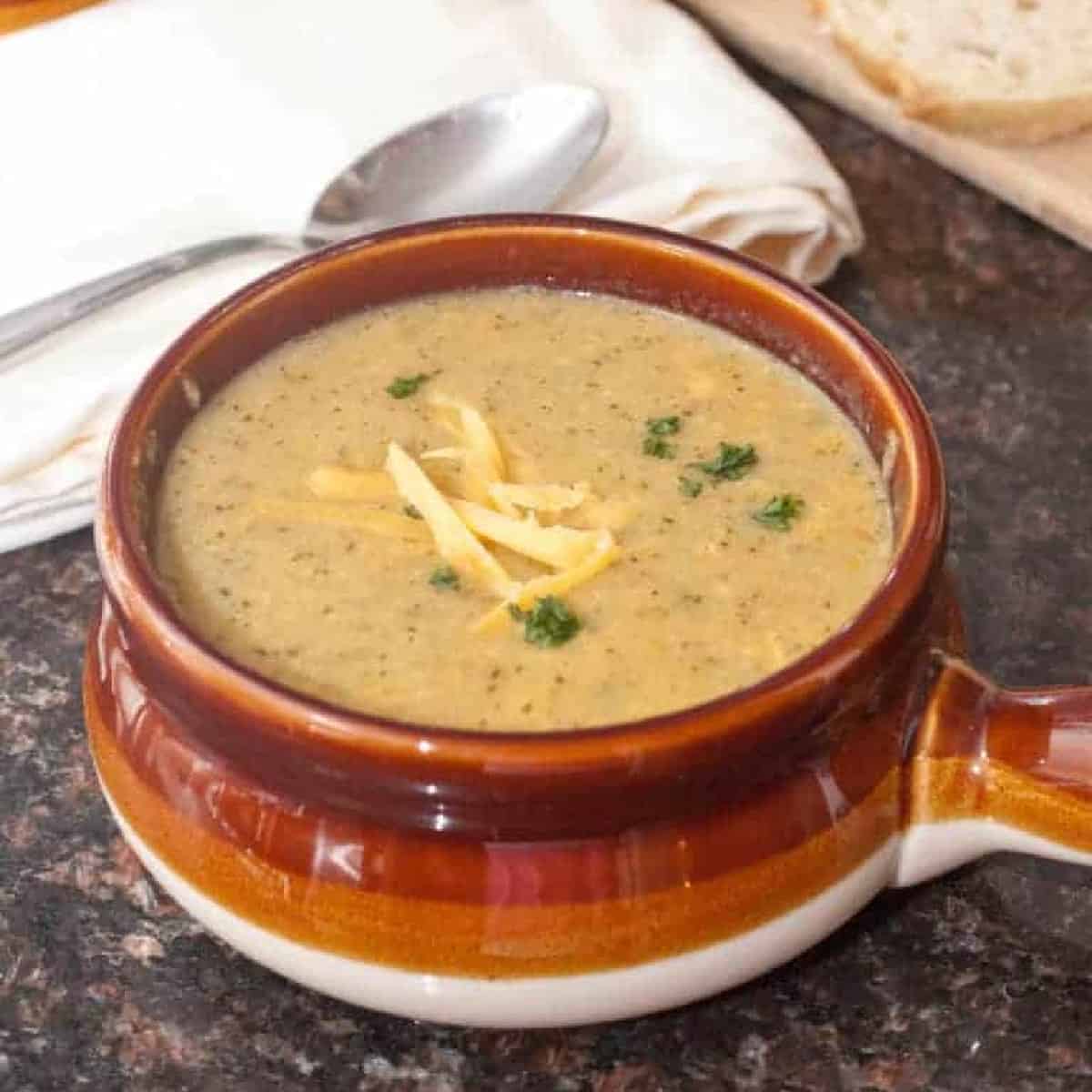 a soup bowl of creamy broccoli cheddar soup. 