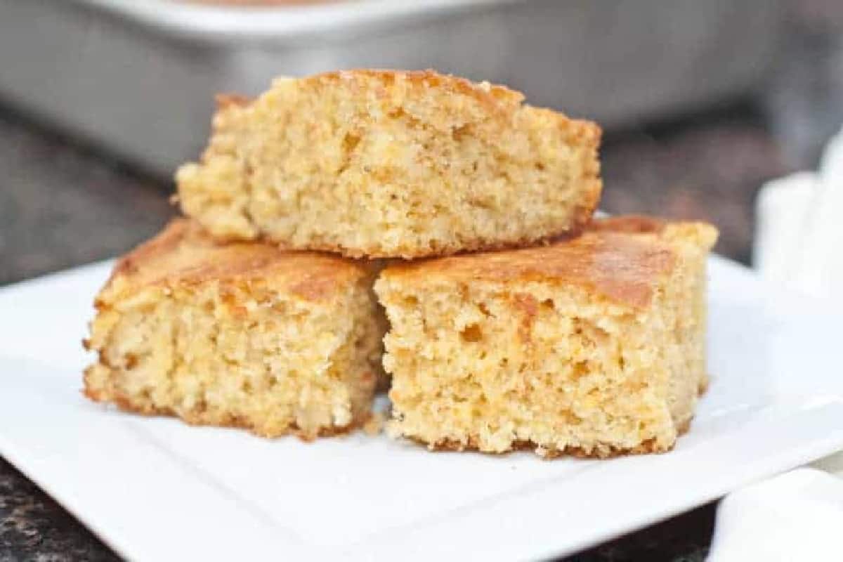 a plate with 3 stacked pieces of cornbread.