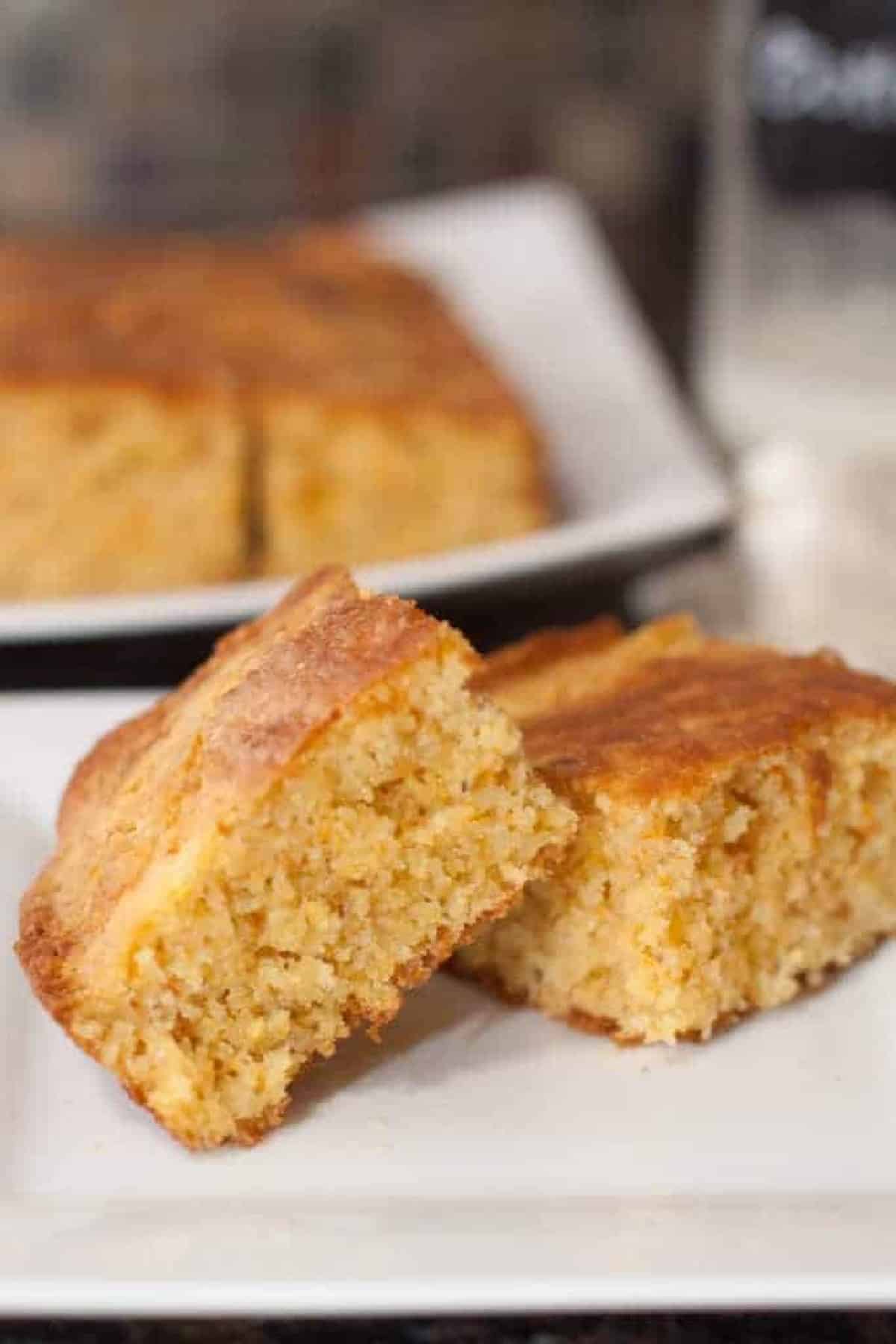 two pieces of cornbread on a plate.