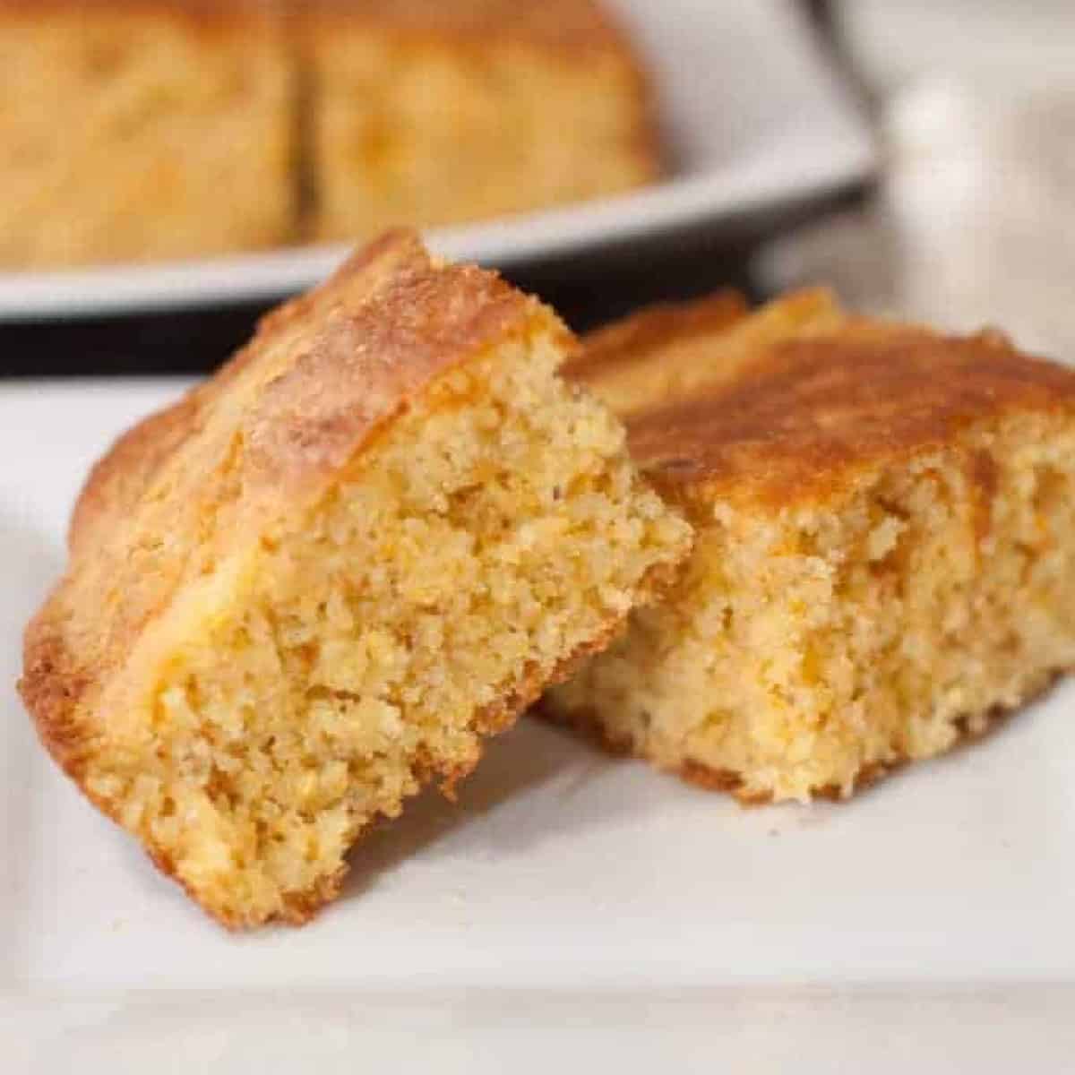 two pieces of cornbread on a plate.