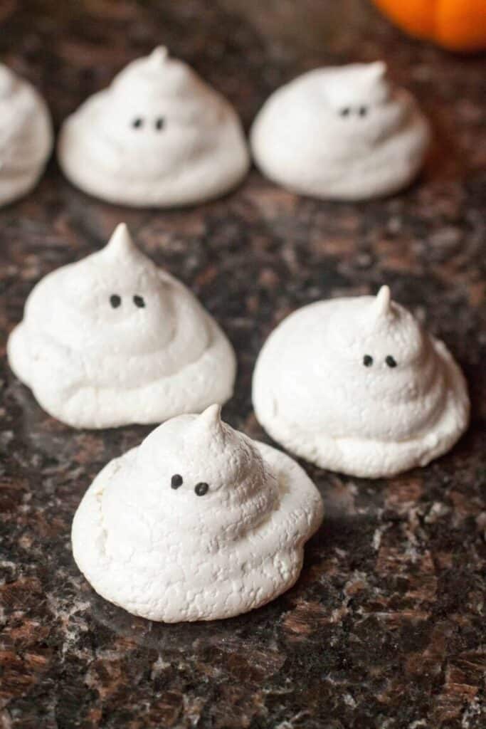 little white meringue cookie in ghost shapes.