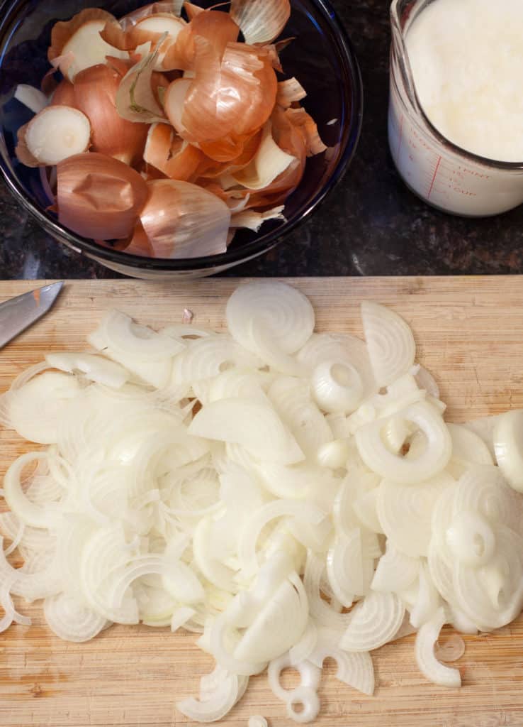 Sliced onions on a cutting board.