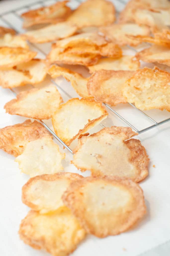 fresh fried chips cooling on a cooling rack