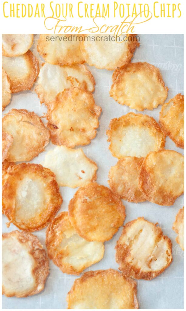 fresh baked homemade chips on a parchment paper on a baking sheet with Pinterest Pin Text.