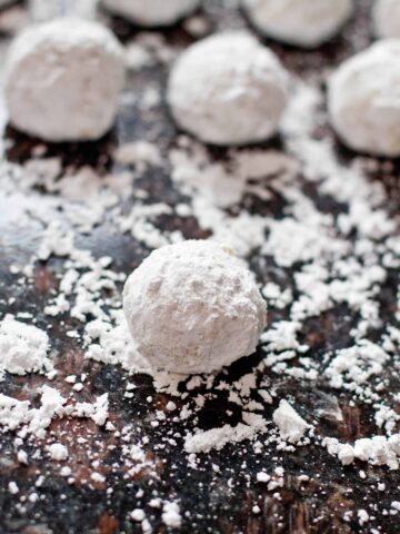 sugar coated butter ball cookies on a sugared counter