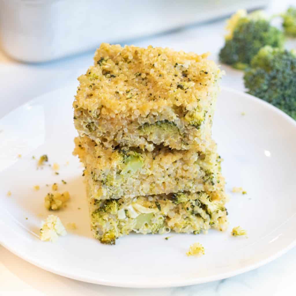 a stack of quinoa broccoli cheddar bars on a plate.