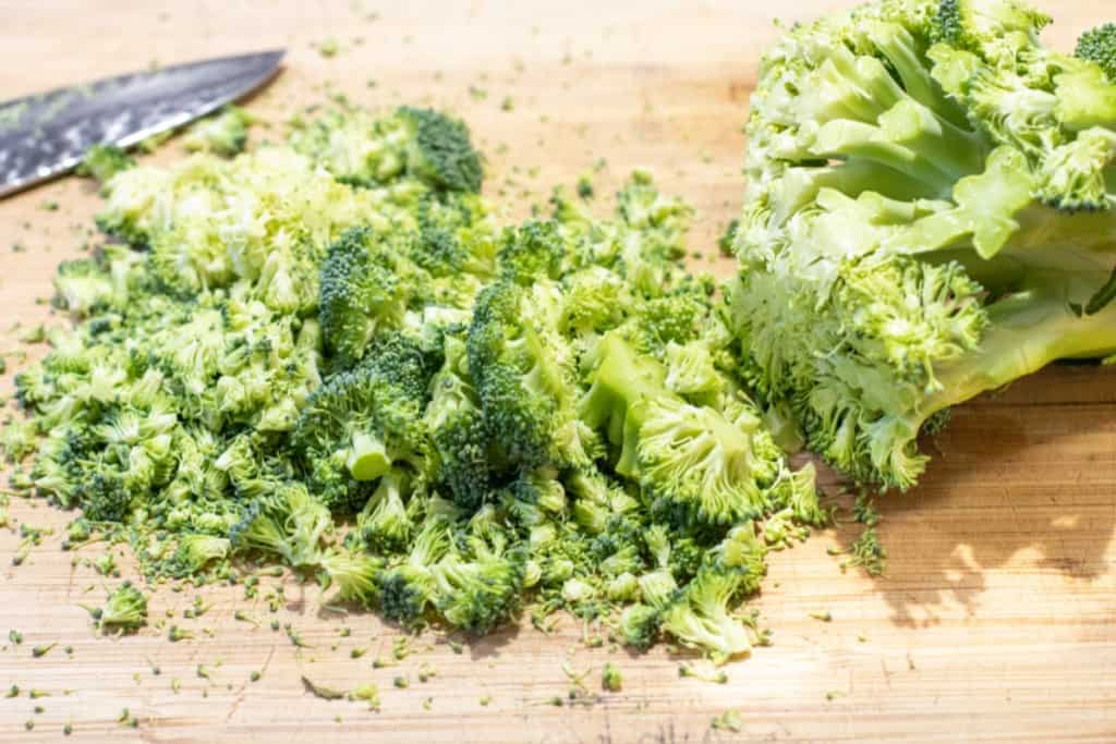 chopped broccoli on a cutting board.
