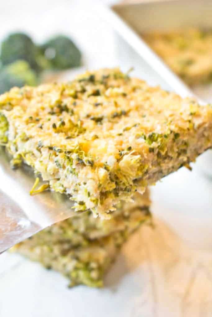 a spatula holding up a quinoa broccoli bar.