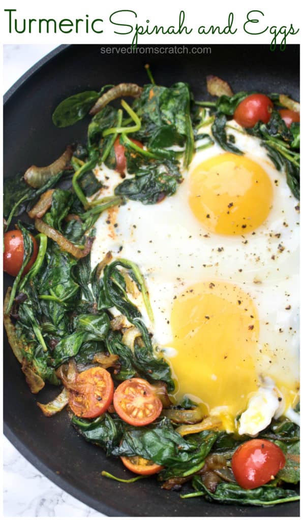 a pan with sauteed spinach, tomatoes, onions, and eggs