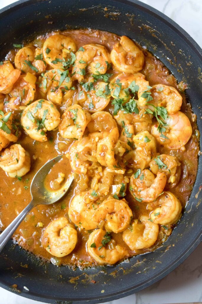 This Super Easy Coconut Curry Shrimp is full of flavor, has a great spicy kick, and is easy and simple enough for a weeknight meal! #shrimp #easy #recipe #thai #coconutshrimpcurry #curry