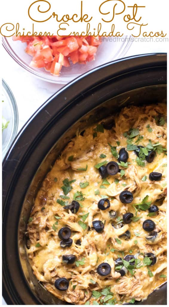 crock with shredded chicken enchilada topped with cheese and sliced olives