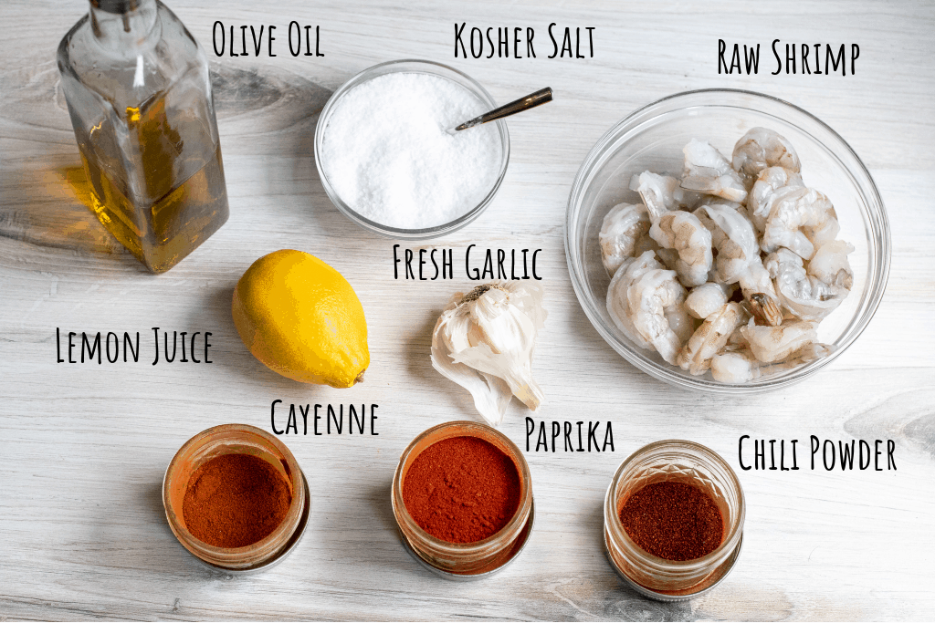 raw shrimp, oil, salt, spices, lemon, garlic on counter labeled.